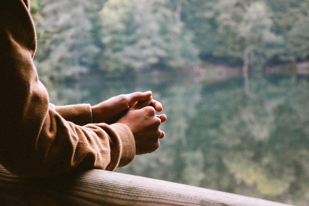 Hands resting on an overlook