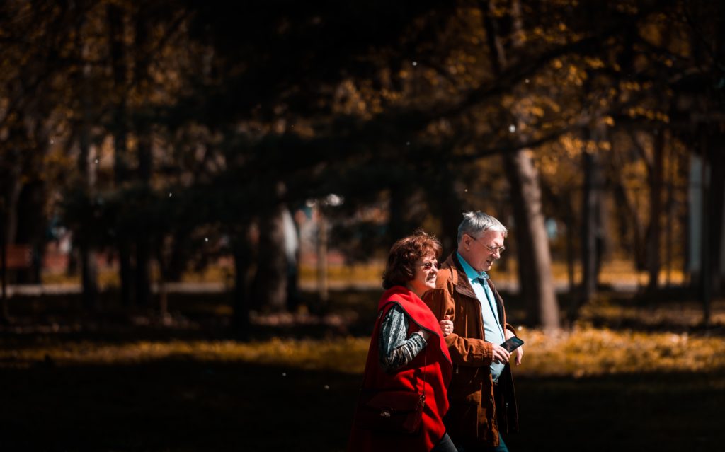 A couple walking through the out
doors.