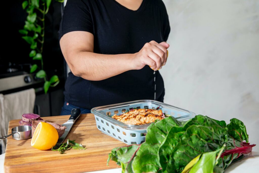 diet for metabolic syndrome, A man in the kitchen of the house cooks a healthy meal of vegetables